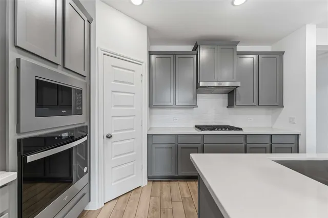 a kitchen with a cabinets and stainless steel appliances