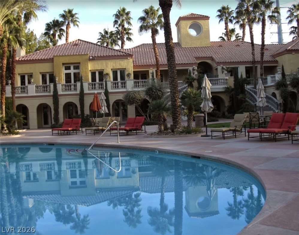 210 East Flamingo Road, Unit 137 Las Vegas, NV 89169 - Photo 31 of 32 An inviting pool reflects the grand Mediterranean-style architecture and swaying palm trees.