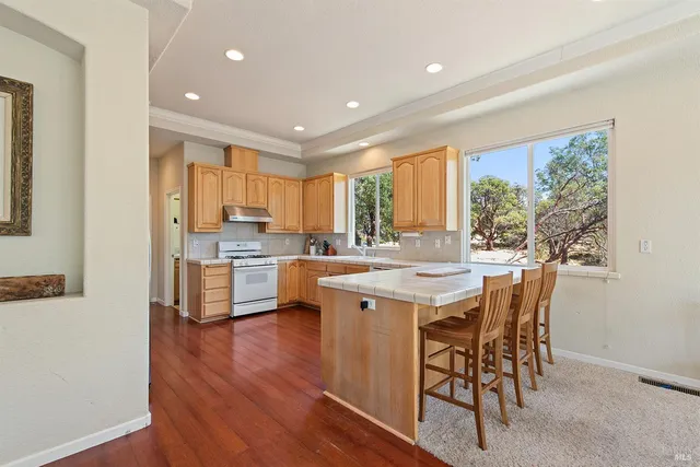 a kitchen with a table chairs sink and cabinets