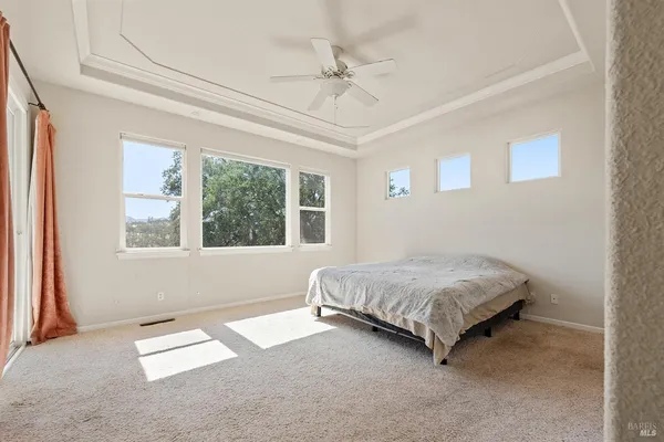 a spacious bedroom with a bed and a window