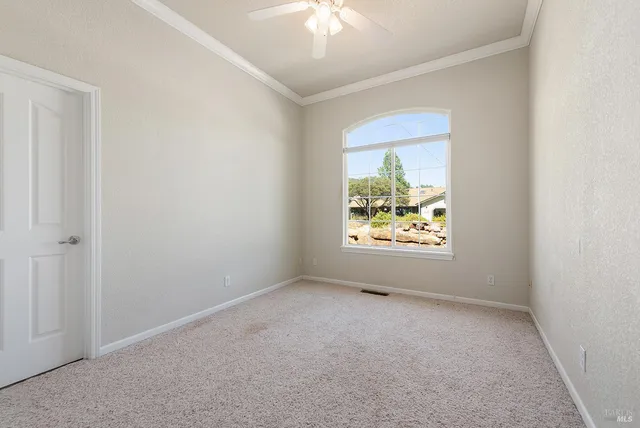 a view of room with window and ceiling fan
