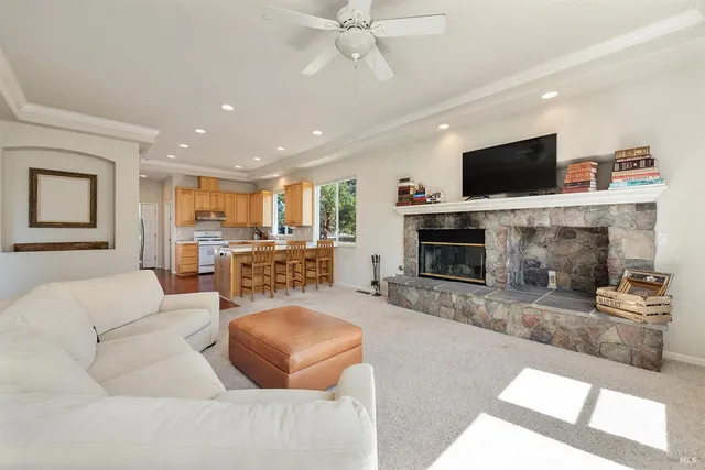 a living room with furniture a flat screen tv and a fireplace