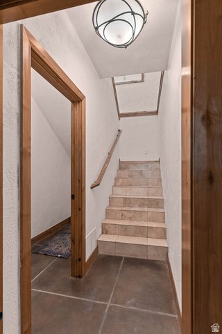 2464 East Granite Way St. George, UT 84790 - Photo 86 of 106 Staircase featuring concrete flooring and a textured wall