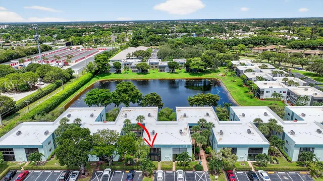 an aerial view of lake and residential houses with outdoor space