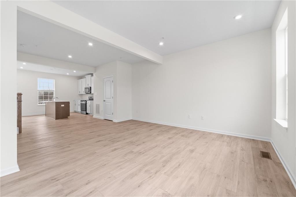 113 Affinity Drive Harmony, PA 16037 - Photo 12 of 40 a view of empty room with wooden floor and windows