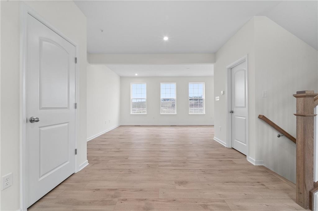 113 Affinity Drive Harmony, PA 16037 - Photo 13 of 40 a view of an empty room with wooden floor and a window