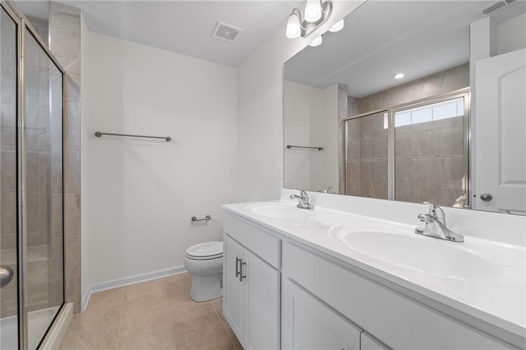 113 Affinity Drive Harmony, PA 16037 - Photo 25 of 40 a bathroom with a double vanity sink toilet and mirror