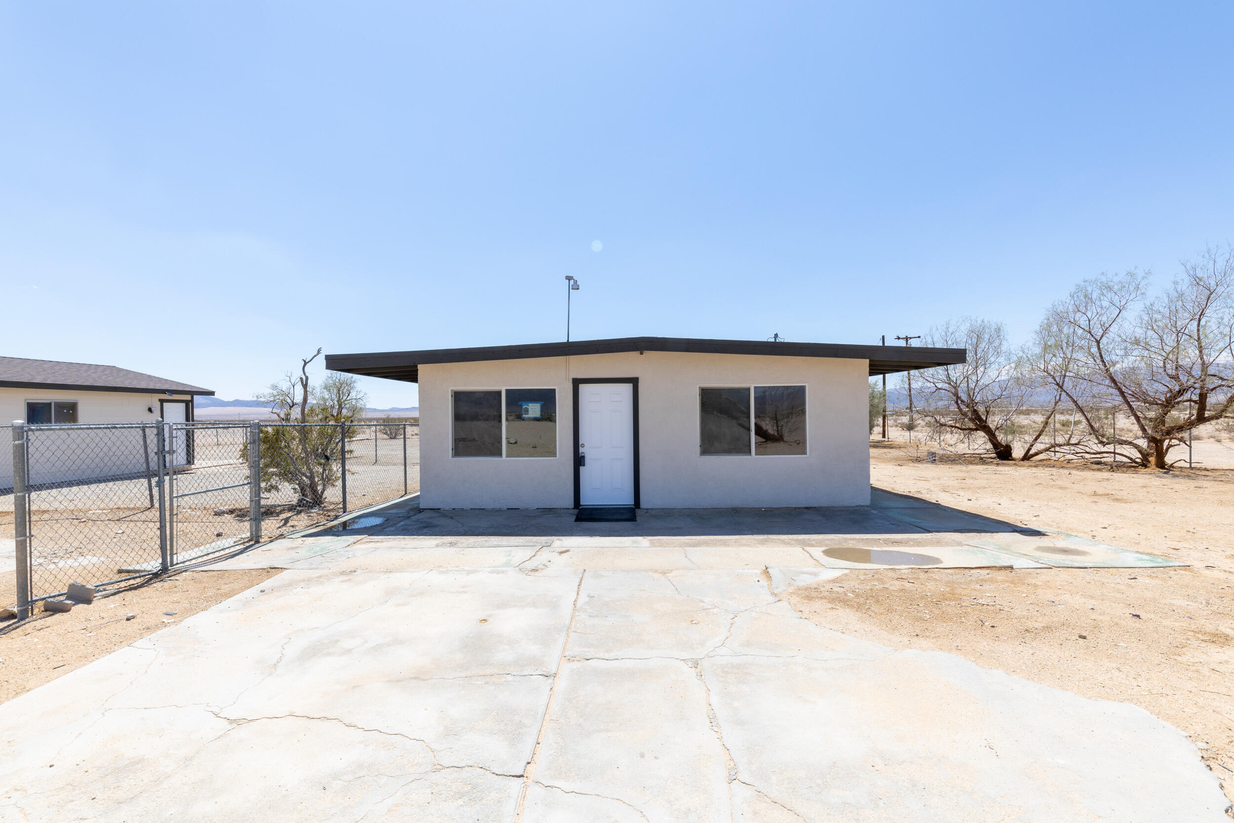 84417 Amboy Road Twentynine Palms, CA 92277 - Photo 20 of 23 a view of house with yard and covered with snow in front of house