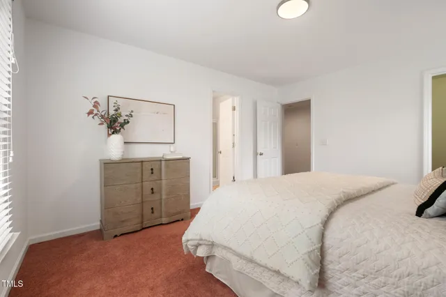 a bedroom with a bed and a dresser