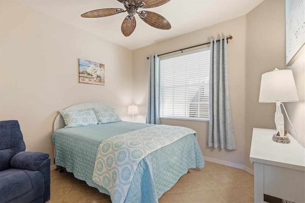 980 Cooper Street, Unit 201 Venice, FL 34285 - Photo 26 of 87 a bedroom with a bed couch and window