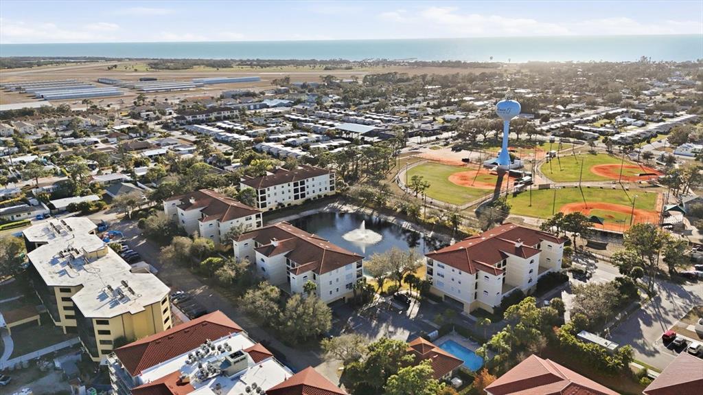 980 Cooper Street, Unit 201 Venice, FL 34285 - Photo 42 of 87 an aerial view of residential building with parking