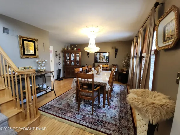 a view of a livingroom with furniture window and wooden floor