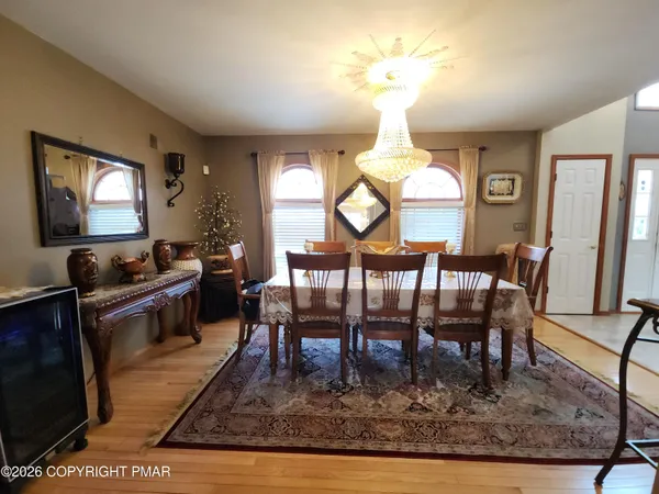 a living room with furniture chandelier and a flat screen tv