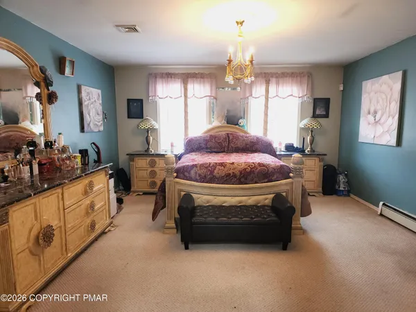 a bedroom with a bed and a couch