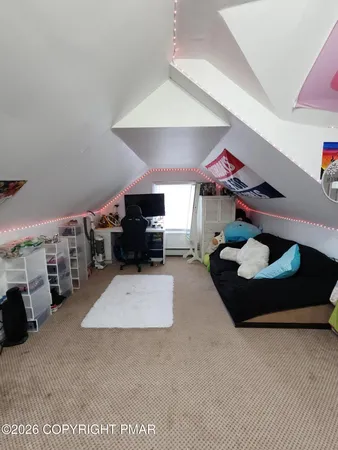 a bedroom with furniture and a window