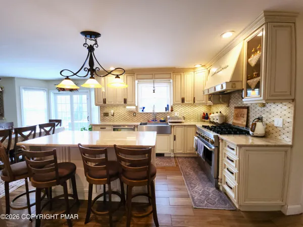 a kitchen with stainless steel appliances kitchen island granite countertop a sink and cabinets