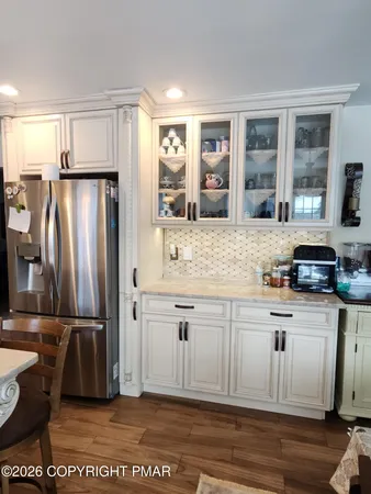 a kitchen with kitchen island granite countertop a stove and white cabinets