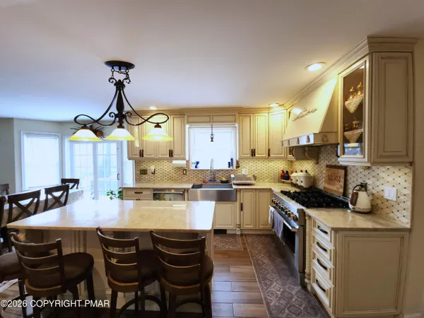 a kitchen with a table chairs stove and cabinets