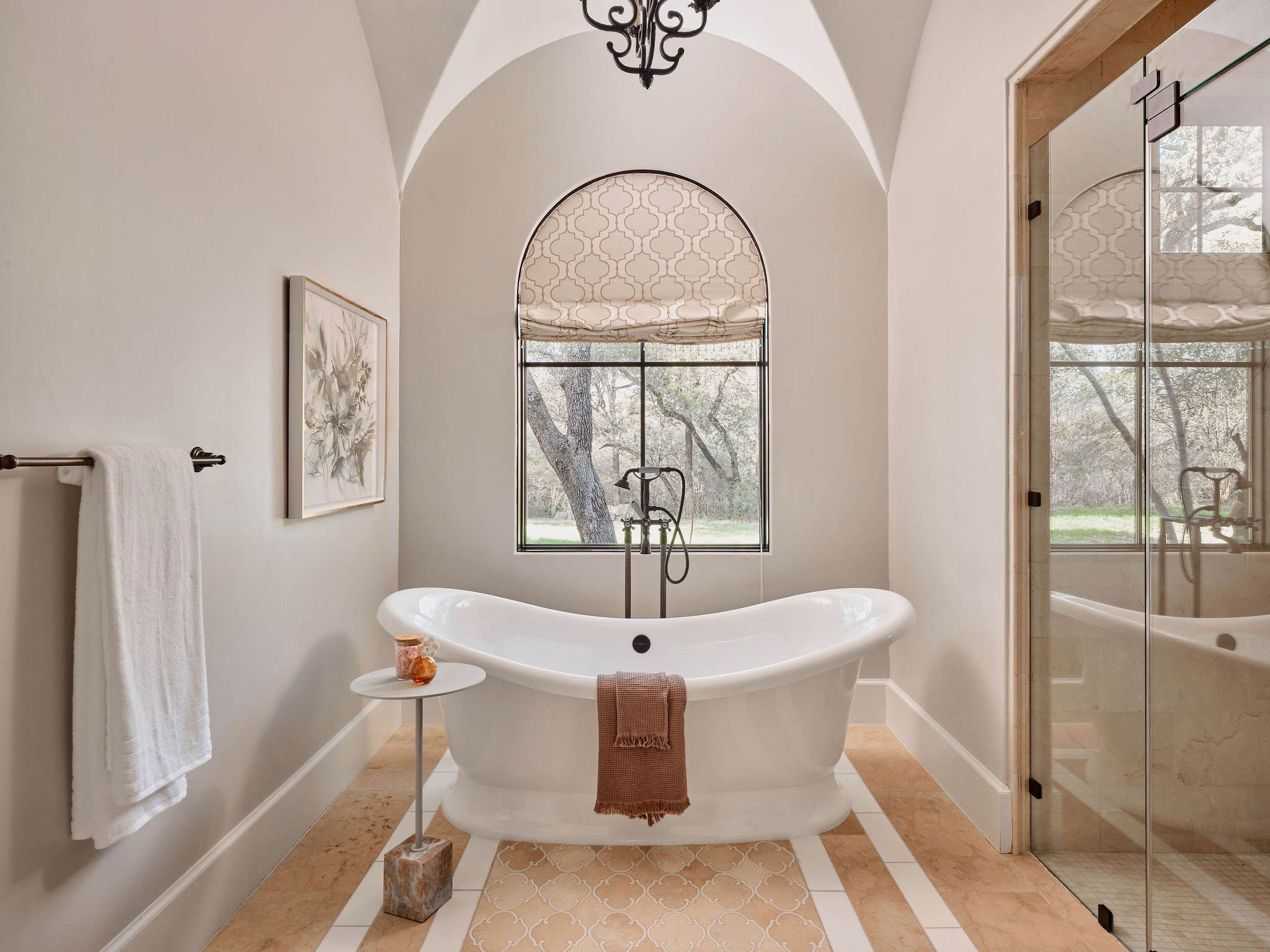3667 Stoneridge Road Austin, TX 78746 - Photo 21 of 40 The soaking tub creates a space of its own, framed by gorgeous arched ceiling details with a private view of the acreage beyond.