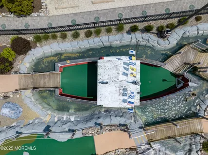 an aerial view of a swimming pool with a yard and mountain view
