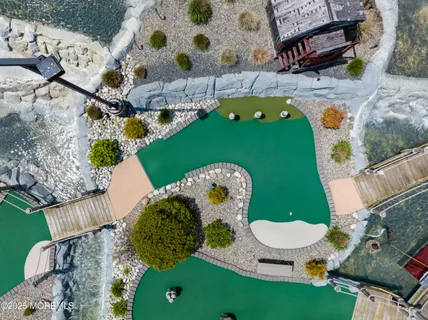 an aerial view of a house with garden space and street view