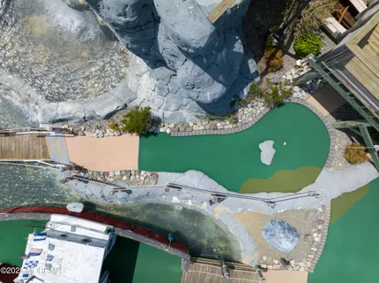 a bathroom with a sink mirror and painting on the wall