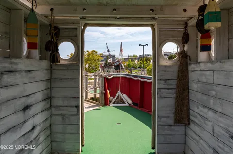a view of a balcony with chairs and wooden floor