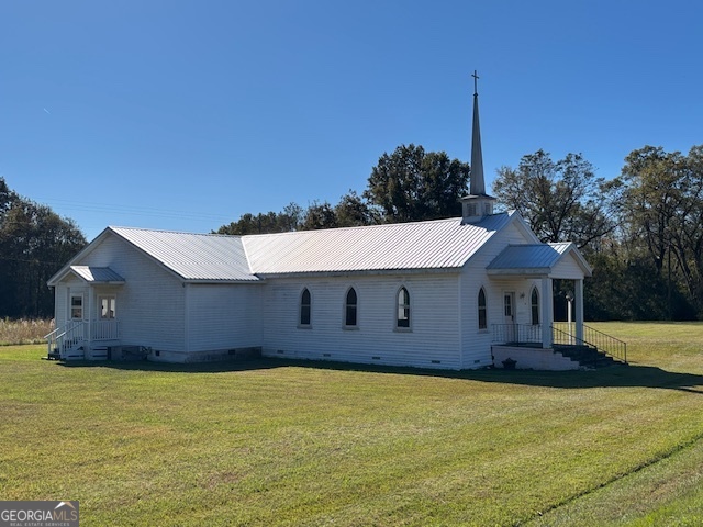 4316 Sharon Road Washington, GA 30673 - Photo 7 of 30 a front view of a house with a garden and yard