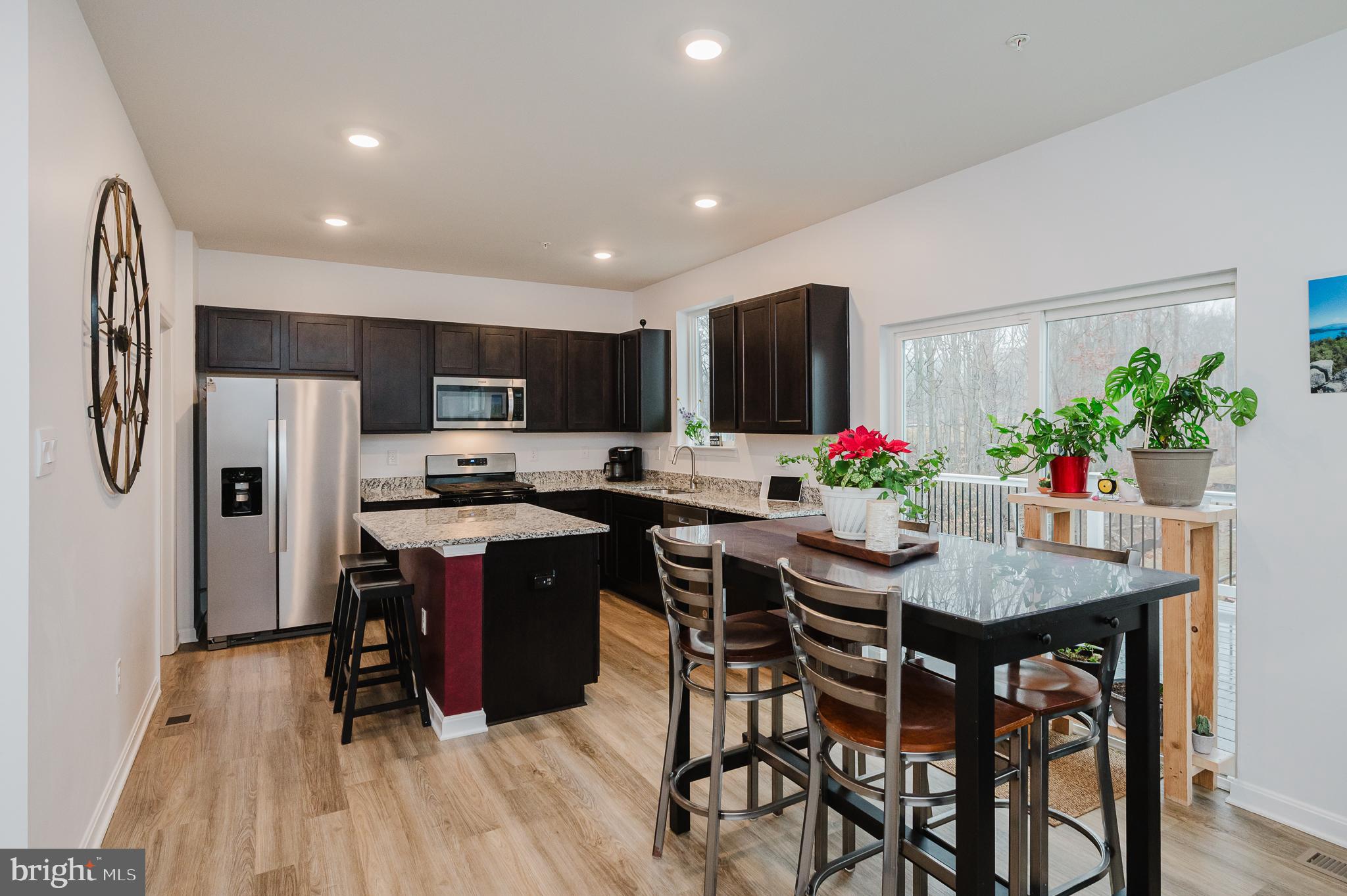 976 Pagonia Road Joppa, MD 21085 - Photo 11 of 69 a kitchen with granite countertop a table and chairs in it