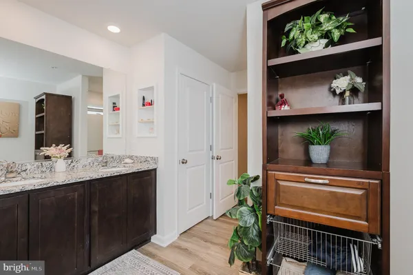 a bathroom with a granite countertop sink toilet and a mirror
