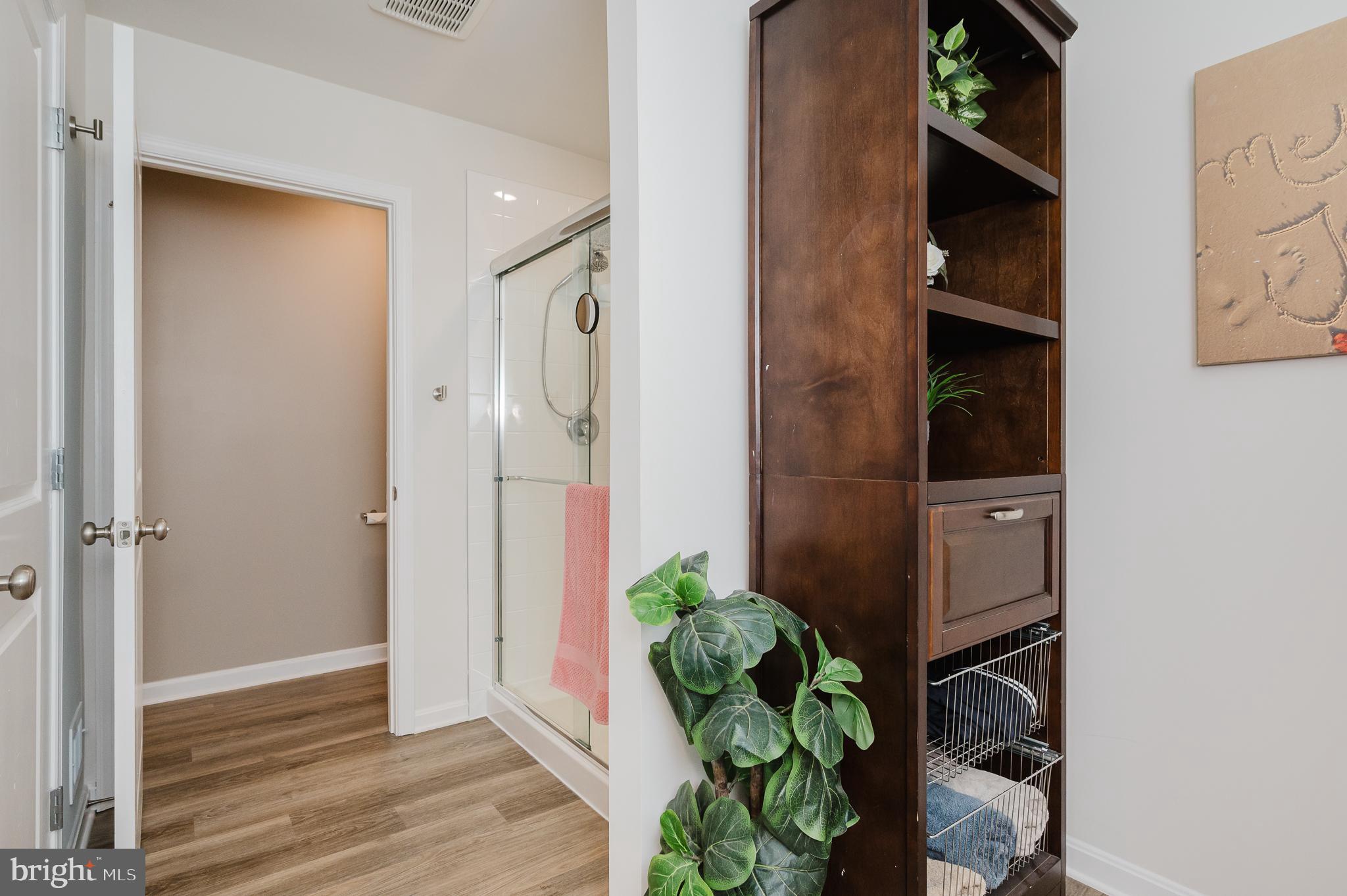 976 Pagonia Road Joppa, MD 21085 - Photo 28 of 69 a view of a hallway with wooden floor and a potted plant