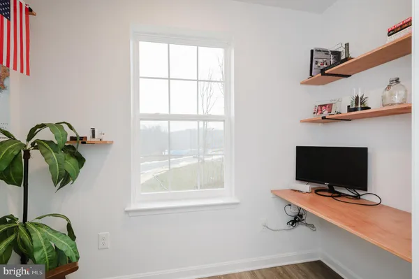 a bedroom with a bed and a potted plant