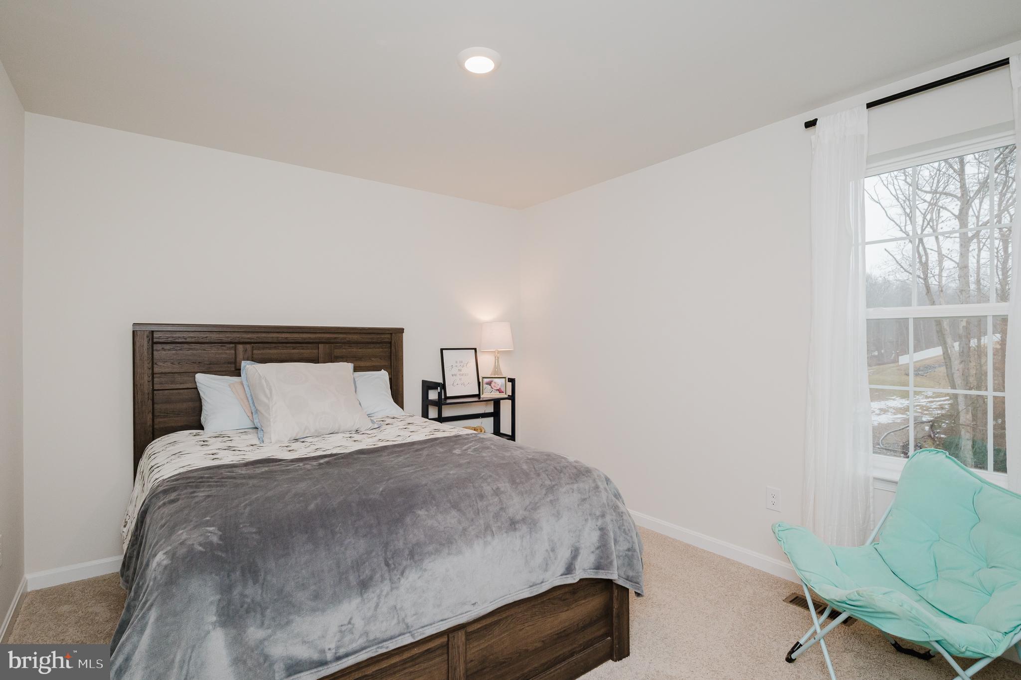 976 Pagonia Road Joppa, MD 21085 - Photo 41 of 69 a bedroom with a bed window and chair