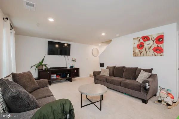 a front view of a house with yard and trees