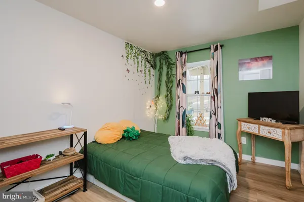 a view of house with yard and trees in the background