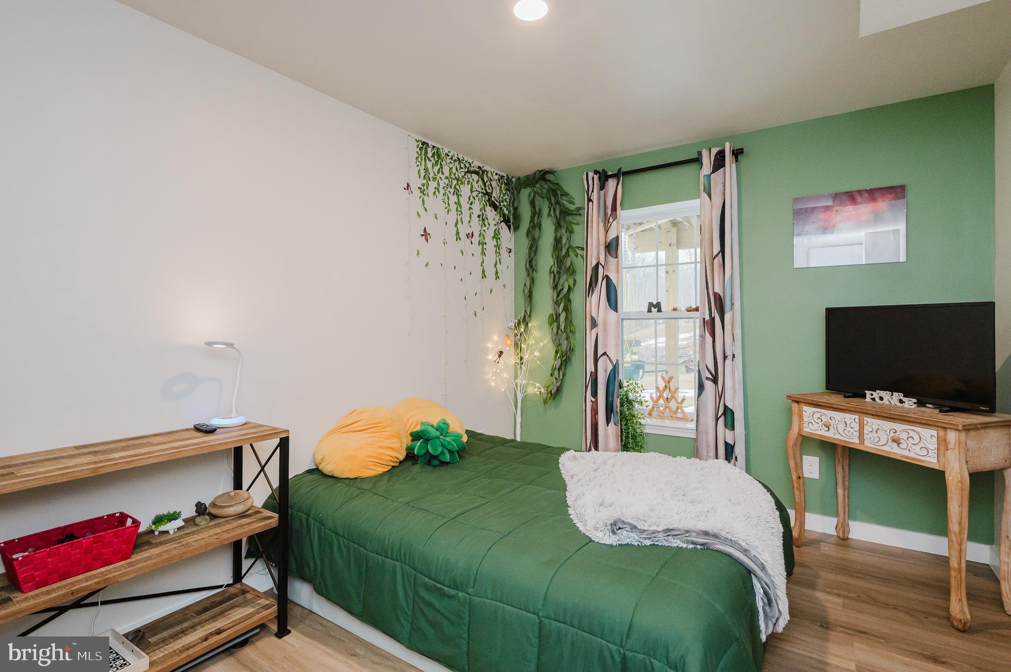 976 Pagonia Road Joppa, MD 21085 - Photo 48 of 69 a bedroom with a bed and a flat screen tv