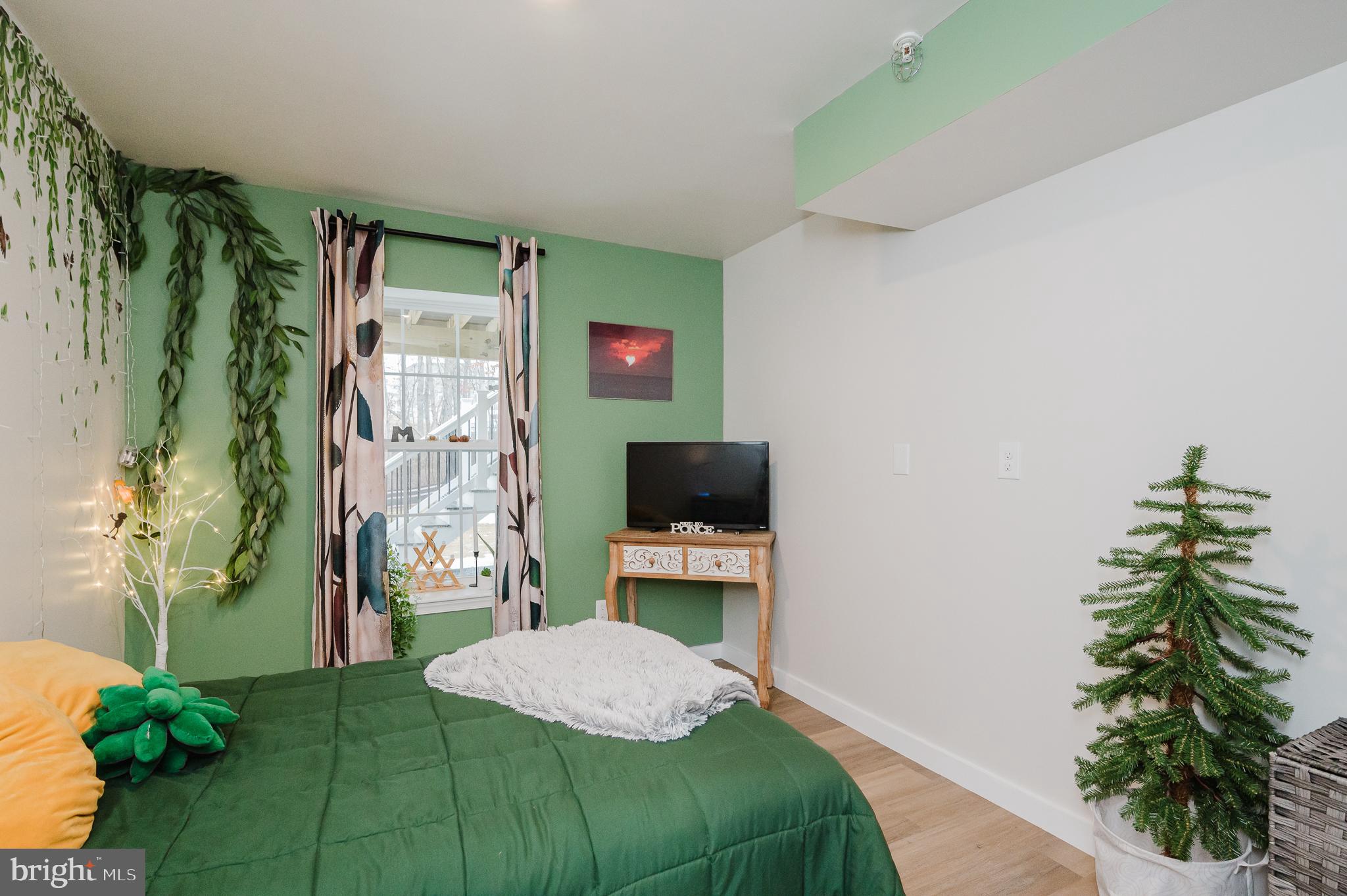 976 Pagonia Road Joppa, MD 21085 - Photo 49 of 69 a bedroom with a bed and a potted plant