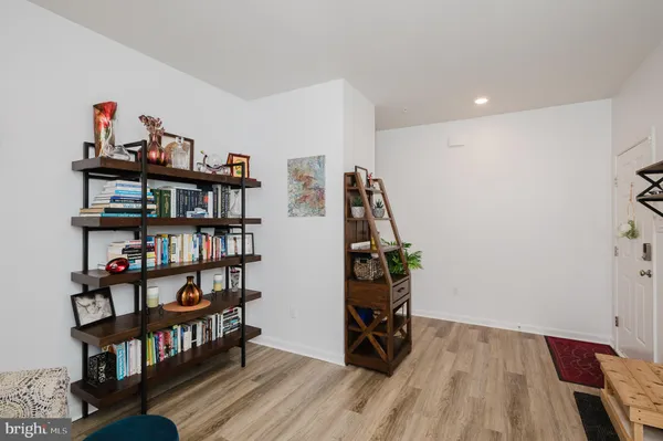 a kitchen with a sink a microwave a refrigerator and chairs