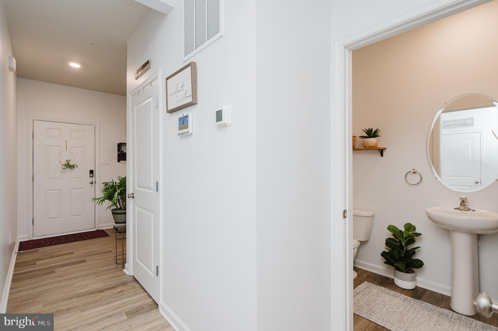 976 Pagonia Road Joppa, MD 21085 - Photo 9 of 69 a view of a hallway to a livingroom and a potted plant