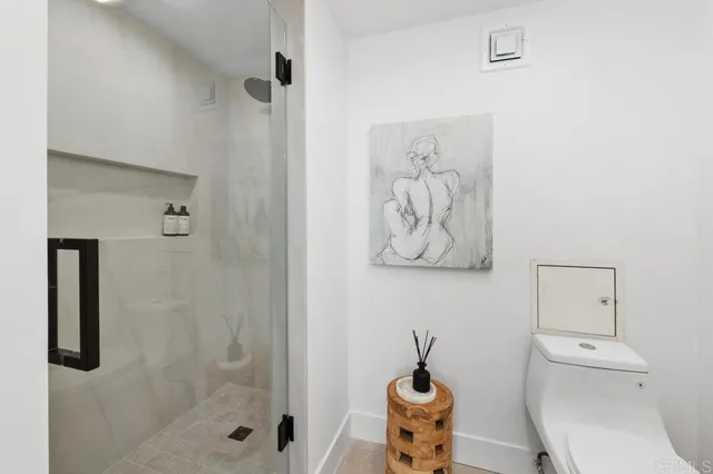 a bedroom with a bed and a painting on the wall