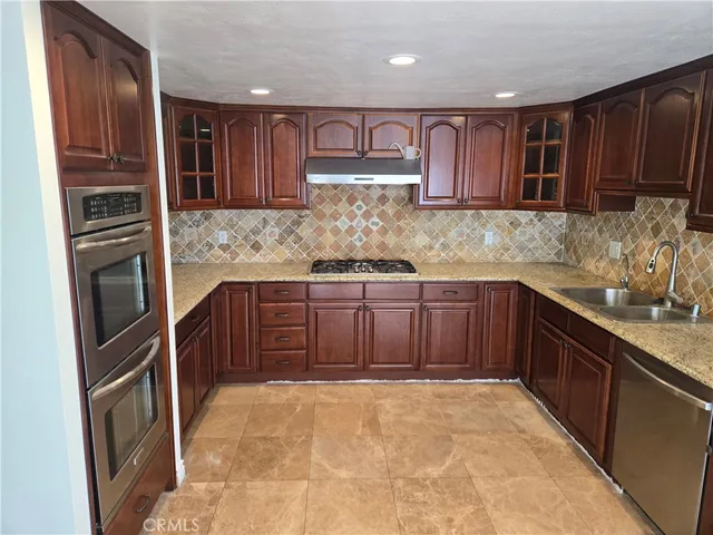 a refrigerator freezer sitting inside of a kitchen