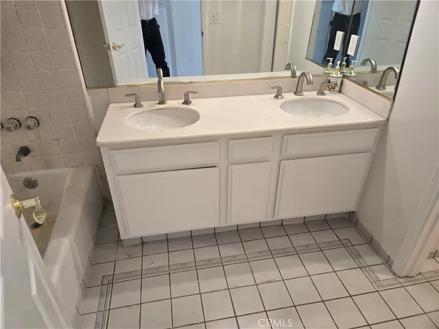a view of a hallway with a chandelier fan and windows