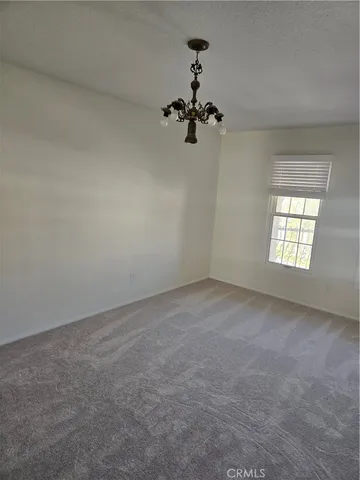 a view of hallway with bathroom and a tub