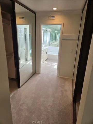 a en suite bathroom with a granite countertop sink mirror and bathtub