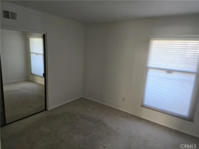 a bathroom with a granite countertop sink a mirror and a shower