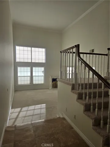 a view of a hallway with a couch and a fireplace