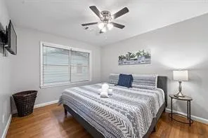 a bedroom with bed and a chair