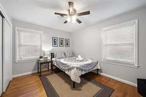 a room with a table chairs and a window