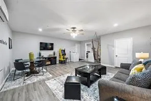 a living room with furniture and wooden floor