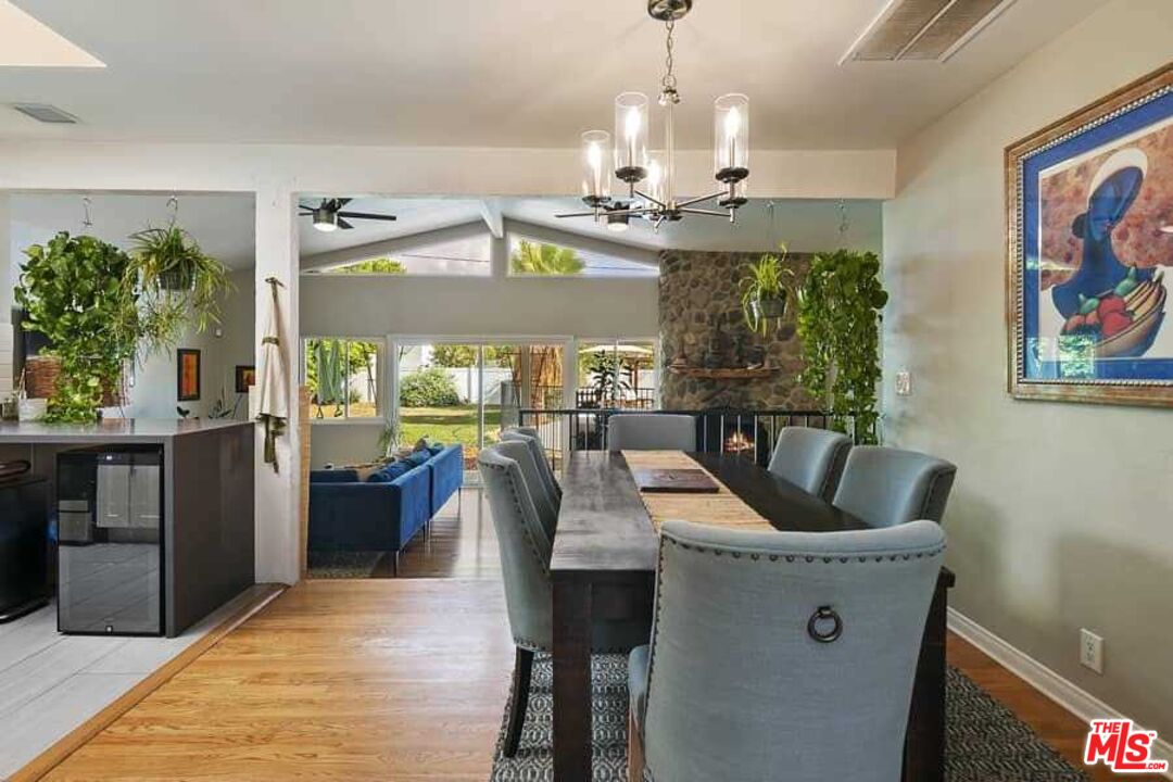 8460 Hatillo Avenue Winnetka, CA 91306 - Photo 1 of 19 a view of dining room and livingroom with furniture wooden floor a chandelier